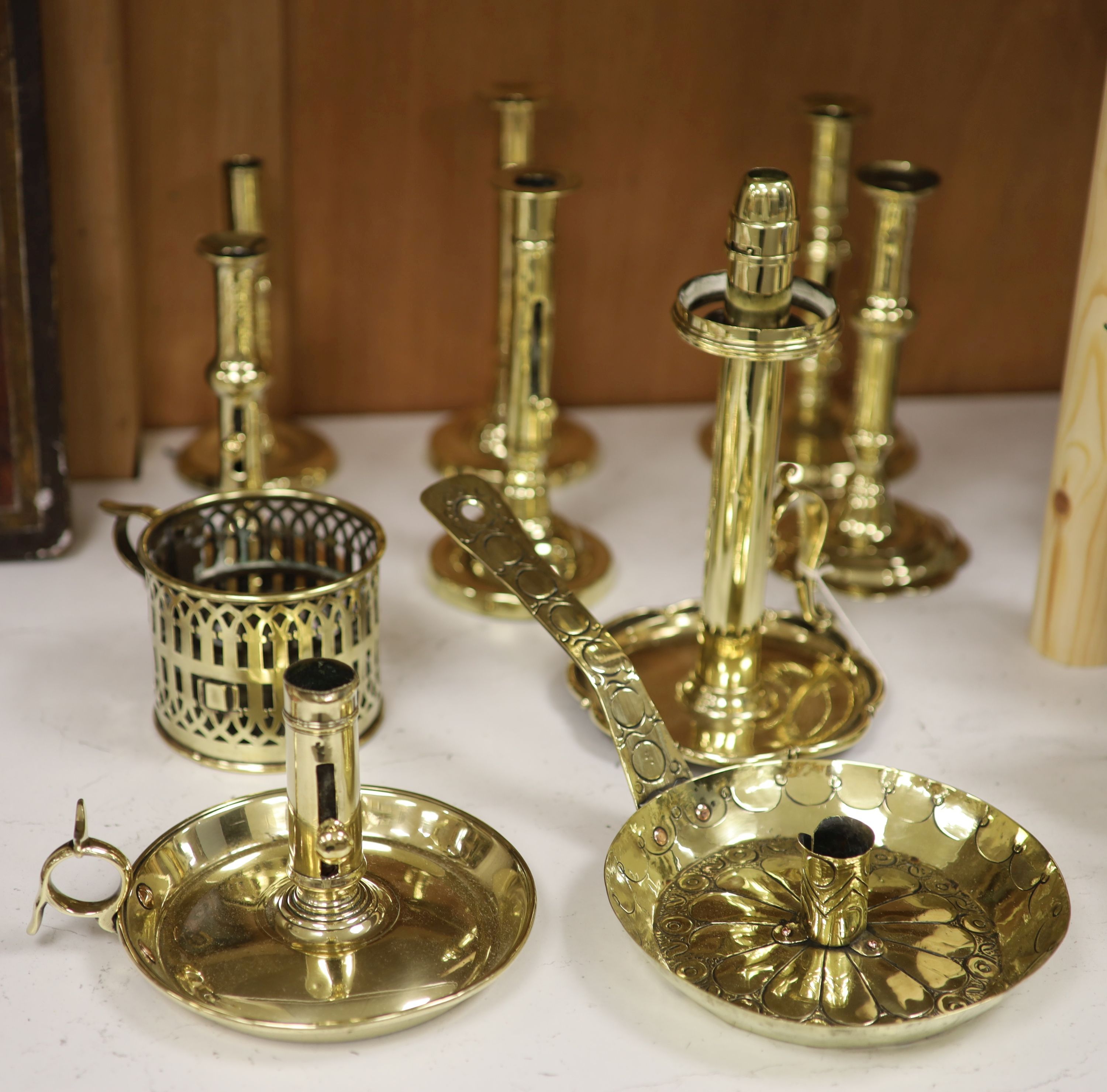 A quantity of 18th/19th century brass ejector candlesticks together with chambersticks, tallest 24cm